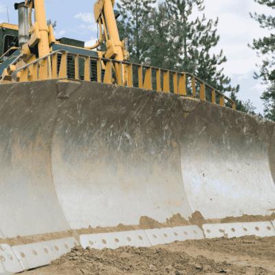 U dozer blade fitted to construction-class bulldozer for high-capacity material pushing